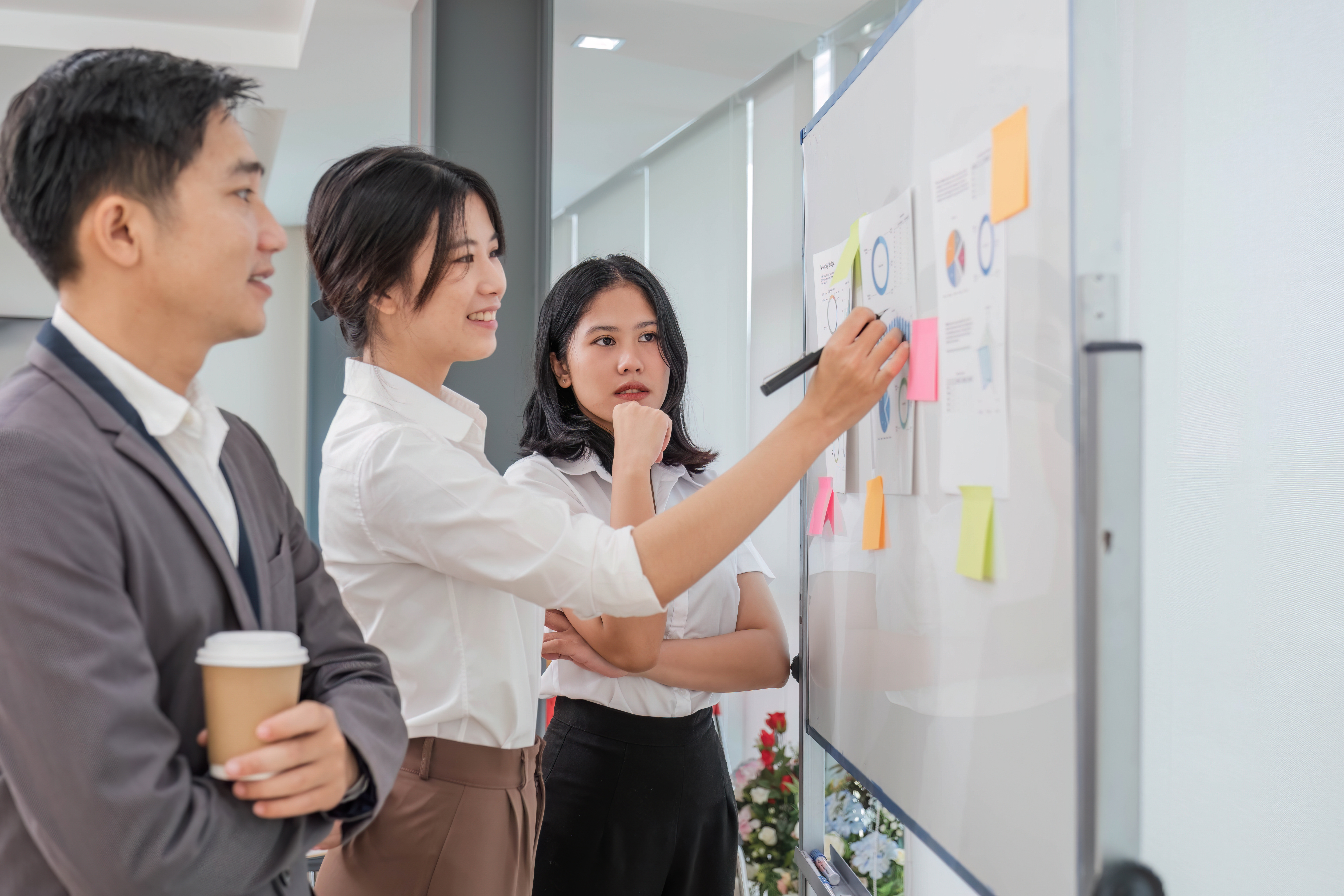 Casual creative happy two smile asian business people plan strategy analysis and brainstorm putting post it sticker note to share idea for startup project on white board at modern office