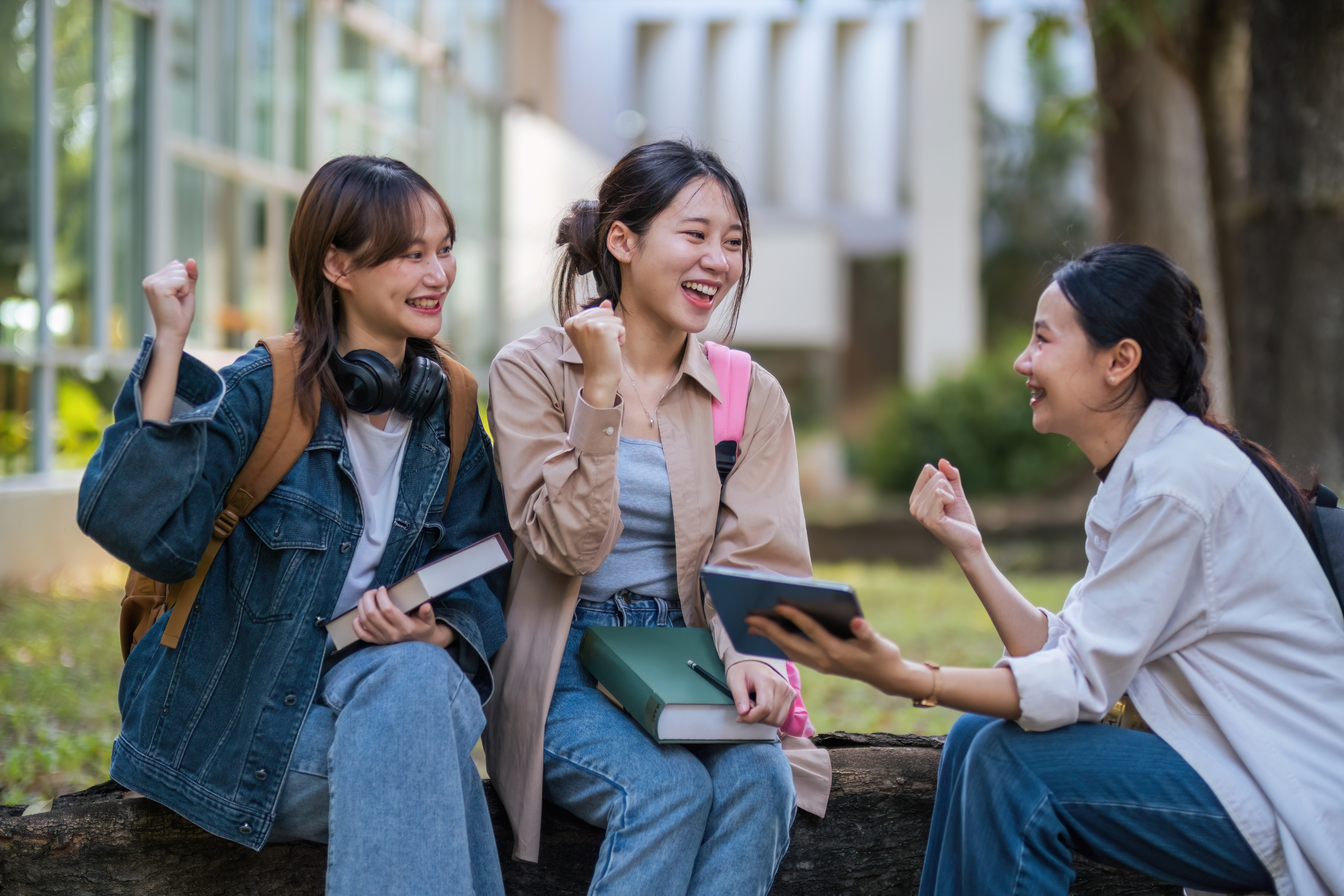 Student university friendship concept with classmate sitting together at campus college park. Youth teenage and education